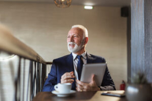 a man in a suit holding a tablet