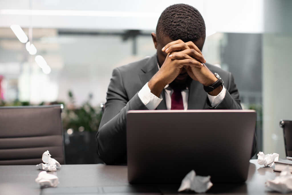 a man in a suit with his hands on his face